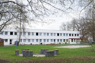 Aussenaufnahme der Suchthilfe mit großem Garten und Volleyball-Anlage